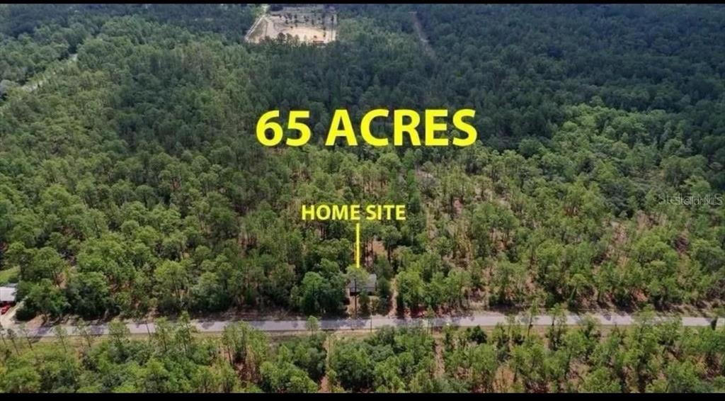 An aerial view shows a house nestled within a large, wooded 65-acre plot of land — SW OBEE RIDGE ROAD, DUNNELLON, FL