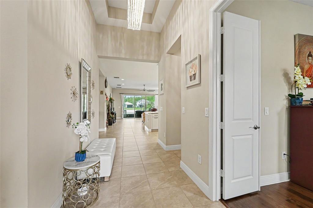 A tiled entryway leads into an open-concept living area with a view of the outdoors — 30867 LINDENTREE DRIVE, WESLEY CHAPEL, FL