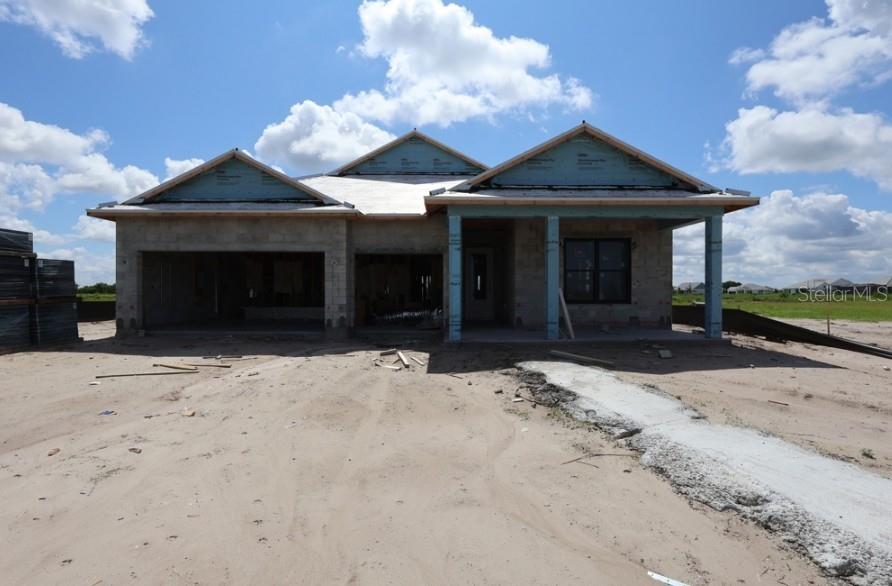 A single-story house under construction with a concrete block exterior and a three-gable roof — 17644 FOXTAIL LOOP, VENICE, FL