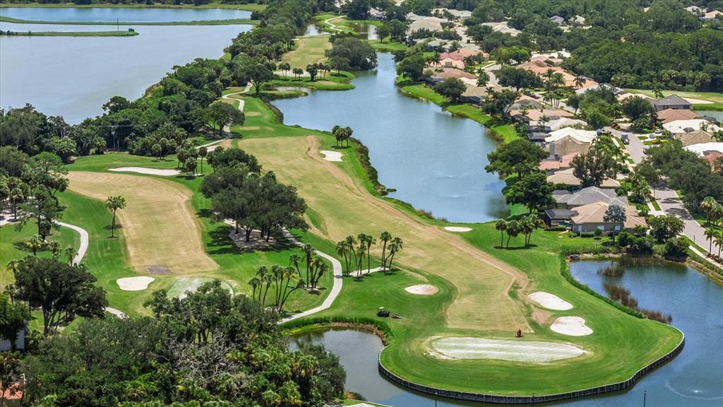 An aerial view of a golf course fairway winding alongside a large lake and houses — 288 VENICE GOLF CLUB DRIVE, VENICE, FL