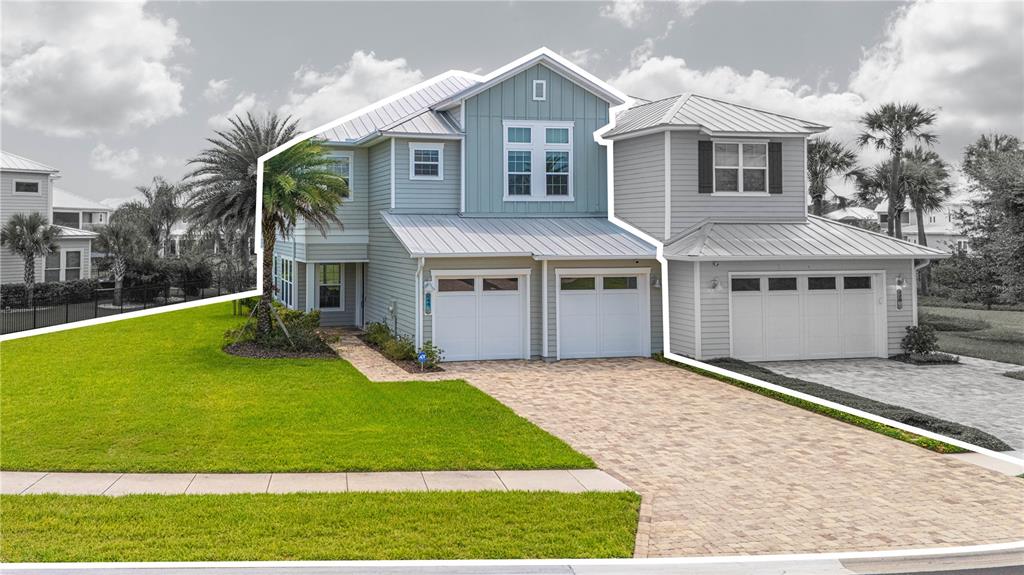 A two-story house with light blue and gray siding features a metal roof and driveway — 244 RUM RUNNER WAY, ST JOHNS, FL