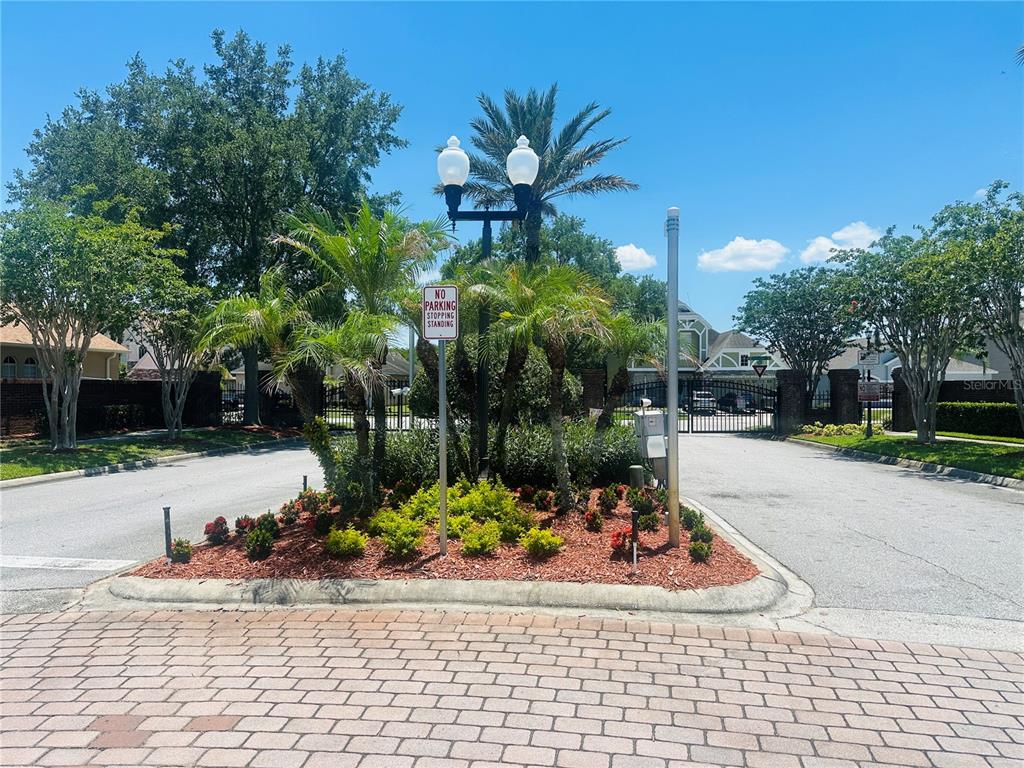 A landscaped traffic island with a street lamp and no parking sign at a gated entrance — 2530 SAND ARBOR CIRCLE, ORLANDO, FL