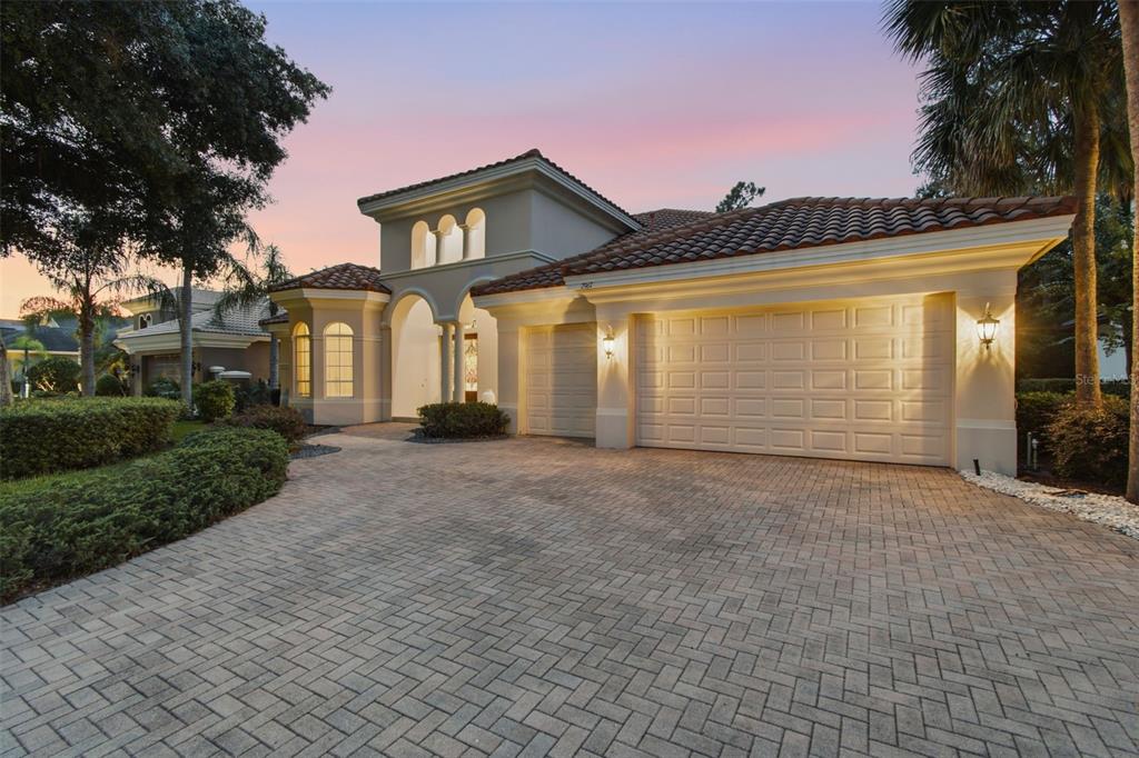 A single-story Mediterranean-style house with a tile roof, three-car garage, and a paved driveway — 2967 GREY OAKS BOULEVARD, TARPON SPRINGS, FL