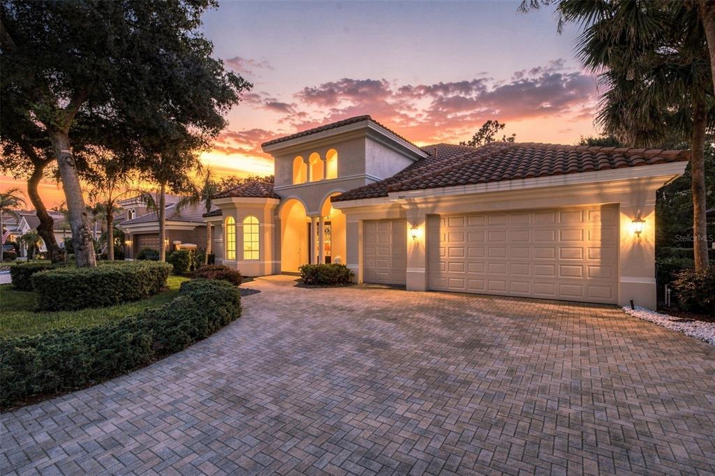 A front entrance with double glass doors, arched windows, and stone columns under a portico — 2967 GREY OAKS BOULEVARD, TARPON SPRINGS, FL