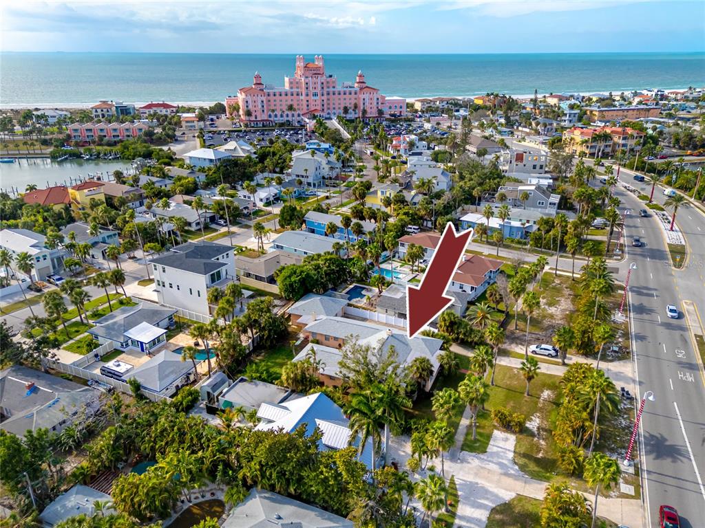 An aerial view shows a residential neighborhood with a red arrow pointing toward a house — 3312 E MARITANA DRIVE, ST PETE BEACH, FL