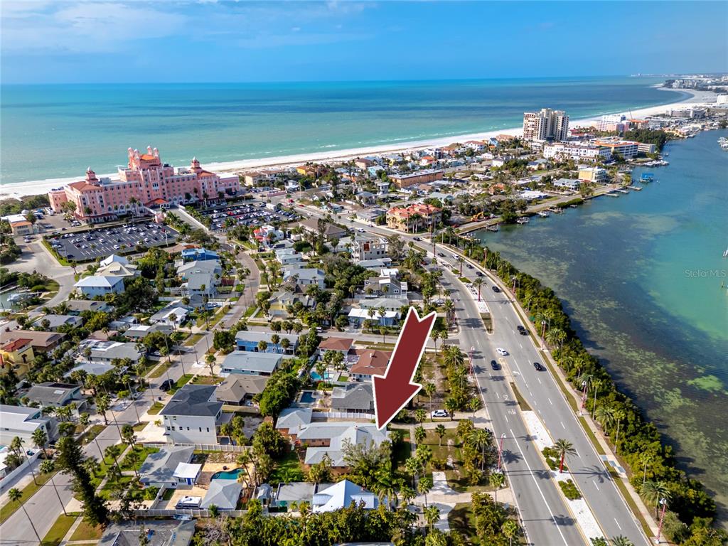 An aerial view shows a residential property marked by a red arrow near the coast — 3312 E MARITANA DRIVE, ST PETE BEACH, FL