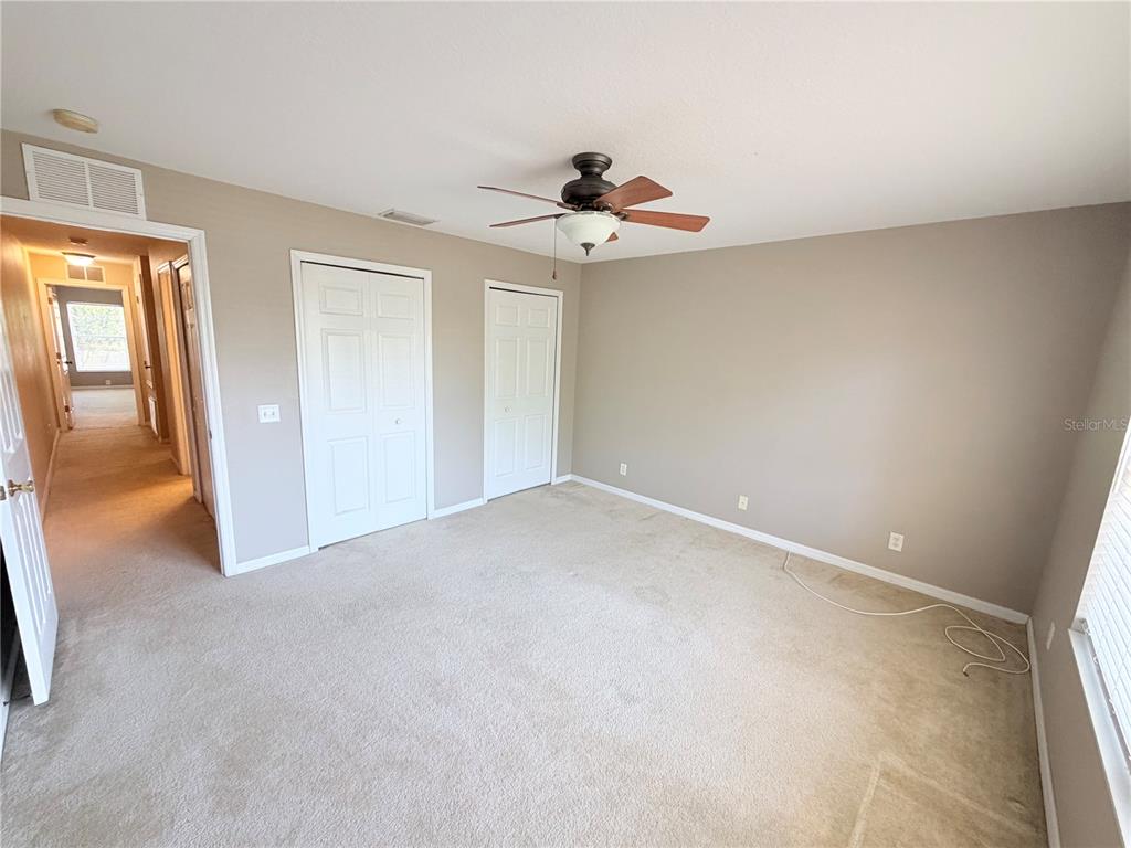 A kitchen features wood cabinets, dark granite countertops, and black appliances — 110 COQUINA BAY DRIVE, ST PETERSBURG, FL