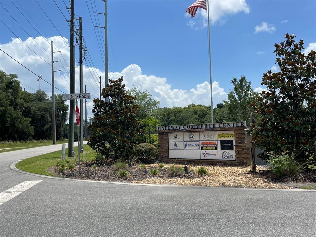 A stone monument sign for Gateway Commerce Center stands at a road intersection — 1020 DUCK BOX ROAD, UMATILLA, FL