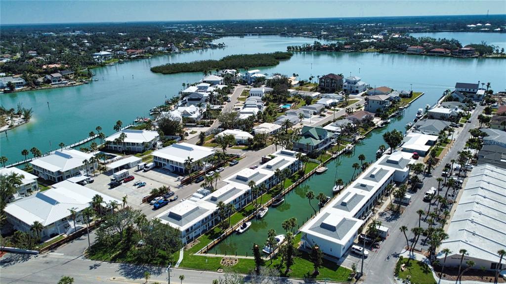 Aerial view of a waterfront residential community with white buildings and boat slips — 902 GIBBS ROAD UNIT 184, VENICE, FL
