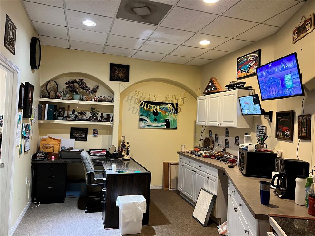 A home office features a desk, built-in shelving, white cabinetry, and a drop ceiling — 2018 N FLORIDA AVENUE, HERNANDO, FL