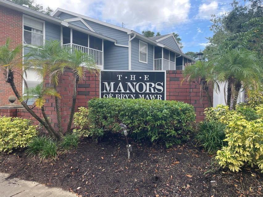 A single-story brick building with a covered entrance and a handicap parking sign outside — 5457 LAKE MARGARET DRIVE UNIT 19-1, ORLANDO, FL
