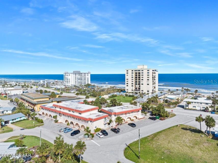 An aerial view shows a multi-story motel complex near a beach and ocean — 1510 OCEAN SHORE BOULEVARD UNIT 3150, ORMOND BEACH, FL