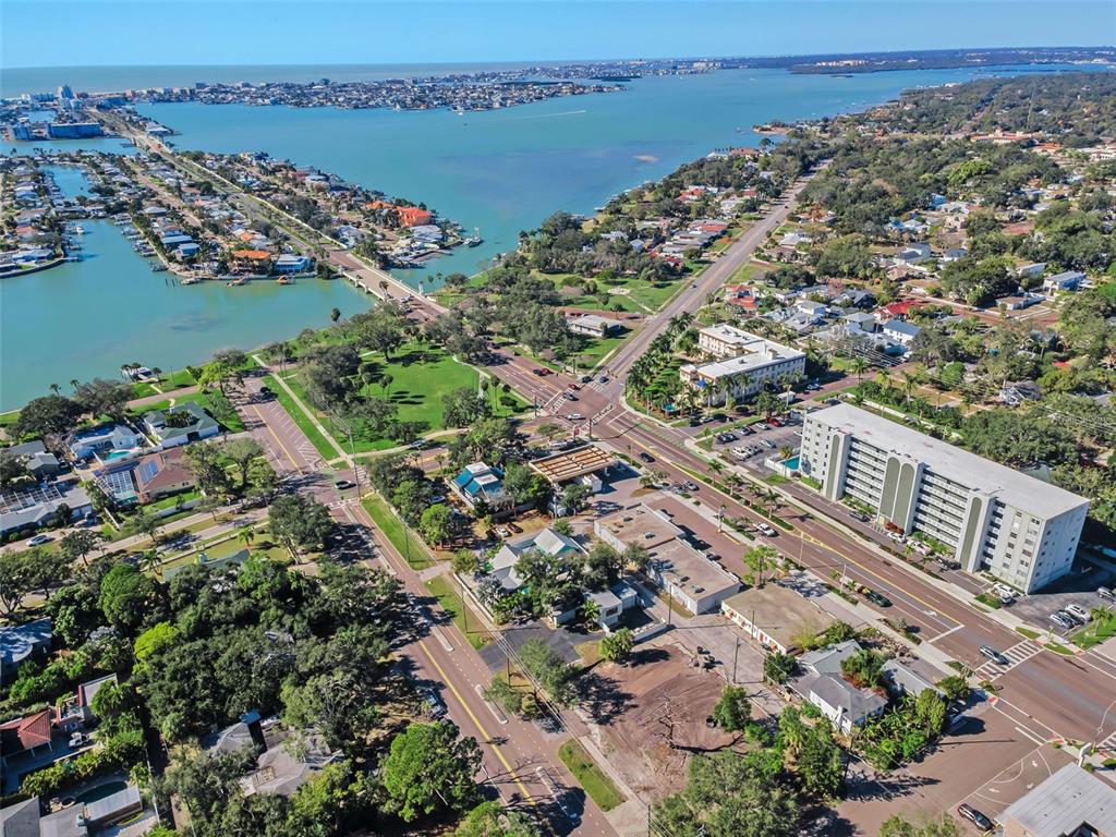 An aerial view shows a cleared, vacant dirt lot situated between a road and buildings — 7309 1ST AVENUE S, ST PETERSBURG, FL