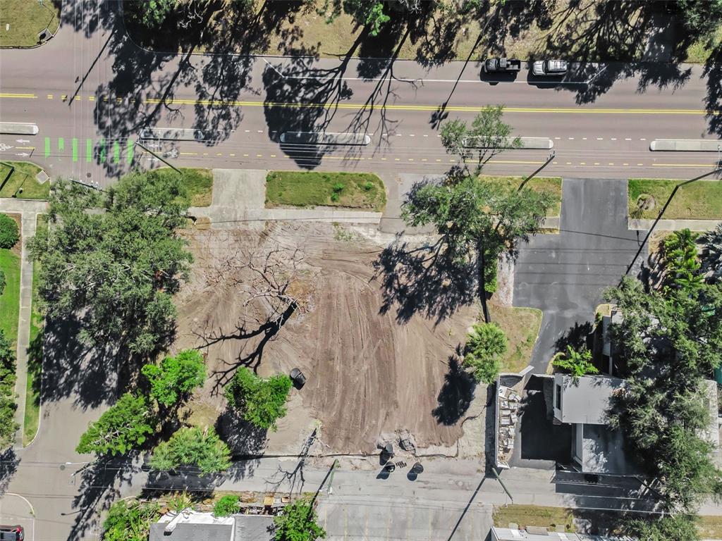 An aerial view highlights a vacant rectangular lot with a small building in a neighborhood — 7309 1ST AVENUE S, ST PETERSBURG, FL