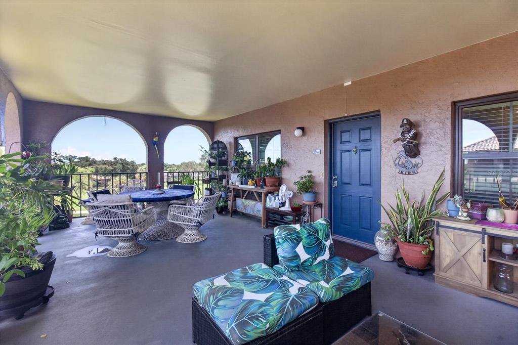 An elevated view of a golf course at sunset with a pond and small building — 6100 GULFPORT BOULEVARD S UNIT 401, GULFPORT, FL