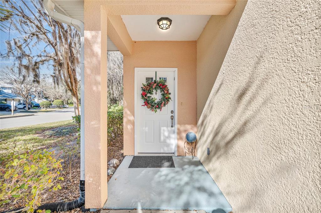 A two-story peach-colored townhouse with a screened-in porch and Spanish moss-covered trees in front — 110 MAGNOLIA CROSSING POINT UNIT 1901, ST AUGUSTINE, FL