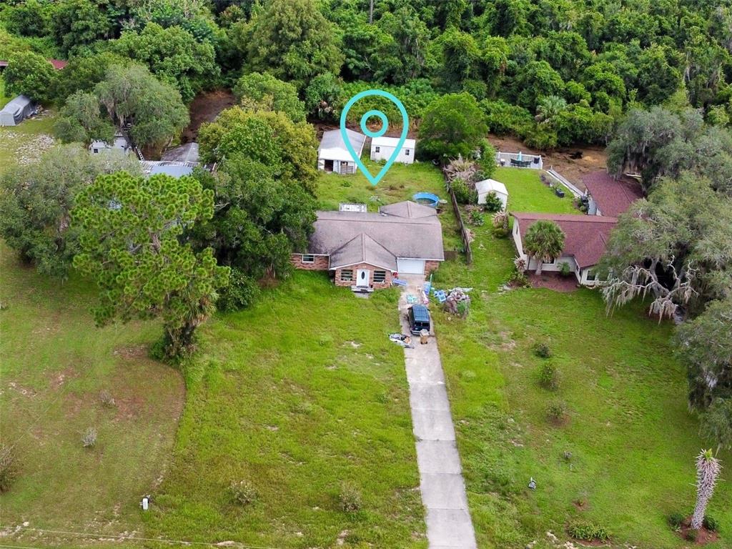 An aerial view shows a single-story house with a long driveway and a detached shed — 5243 EAGLES NEST ROAD, FRUITLAND PARK, FL