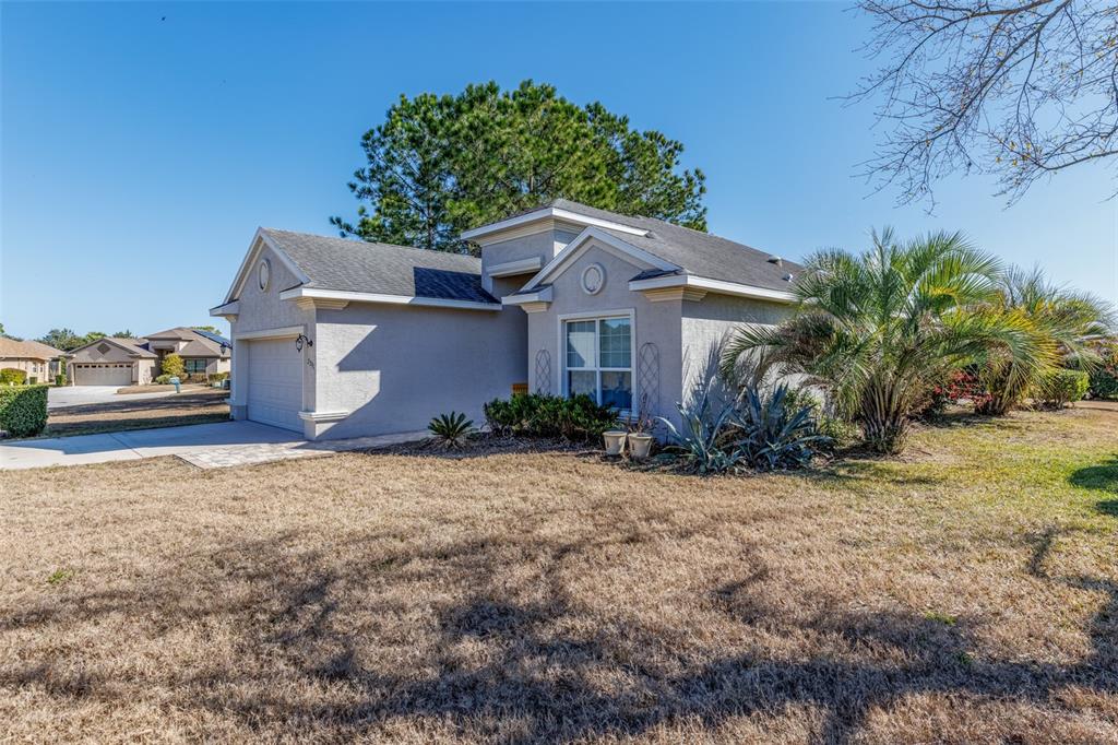 A single-story house with a beige stucco exterior, a garage, and a dry lawn — 2291 N MIA POINT, LECANTO, FL