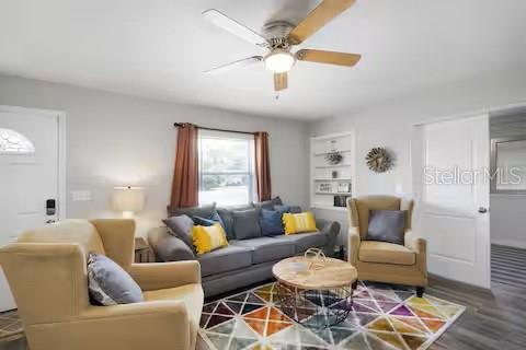 A living room features a gray sofa, two tan armchairs, and a patterned area rug — 305 LINDEN DRIVE, ELLENTON, FL