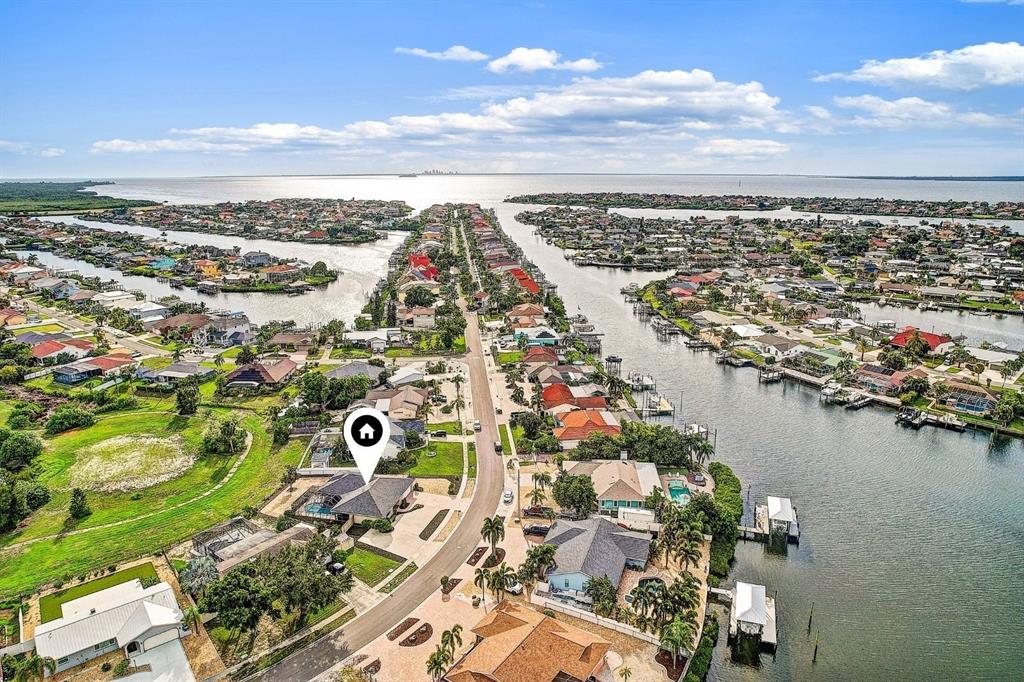 An aerial view shows a waterfront residential neighborhood with a house marked by a pin — 756 FLAMINGO DRIVE, APOLLO BEACH, FL