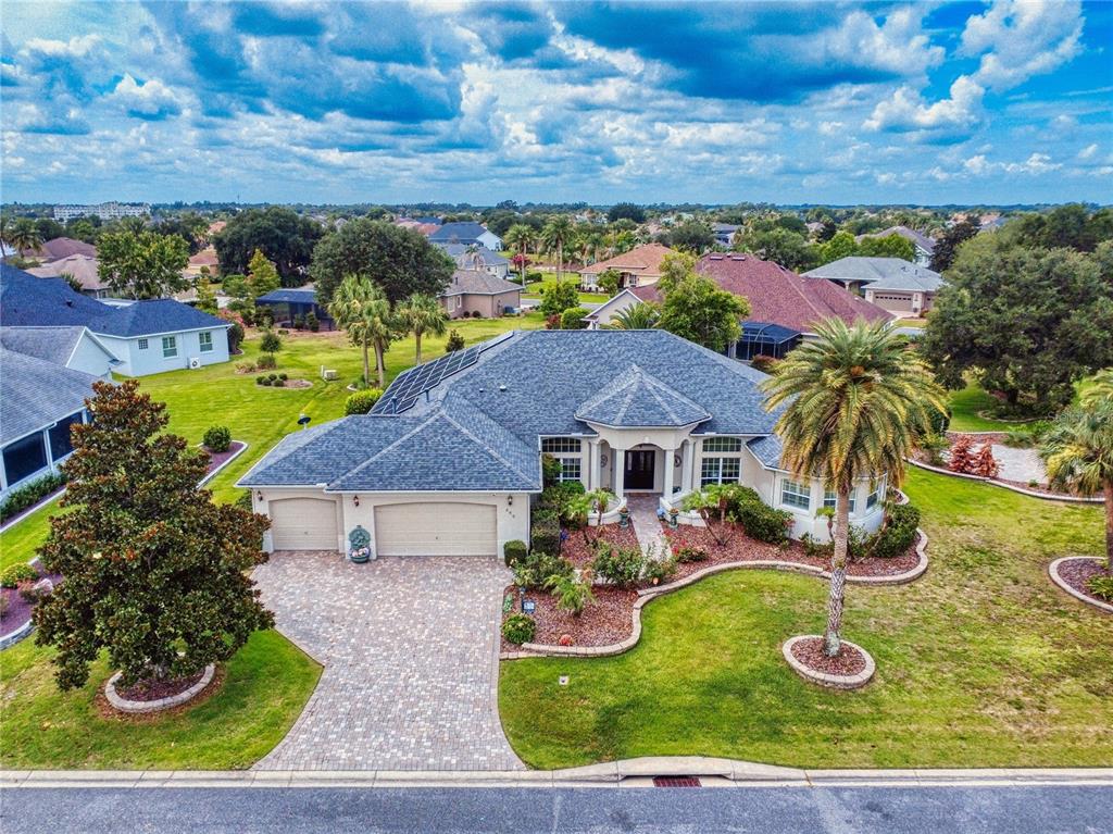 The exterior of a house features a stone walkway leading to double front doors — 649 TERNBERRY FOREST DRIVE, THE VILLAGES, FL