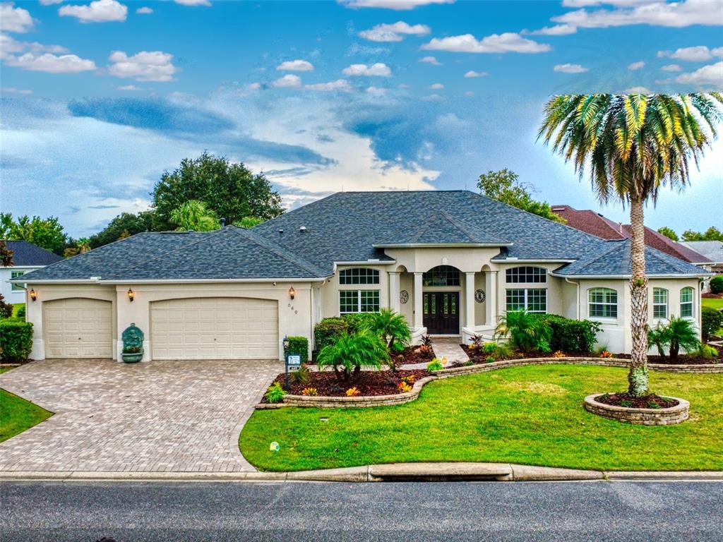 An aerial view of a single-story house with a paved driveway and solar panels — 649 TERNBERRY FOREST DRIVE, THE VILLAGES, FL