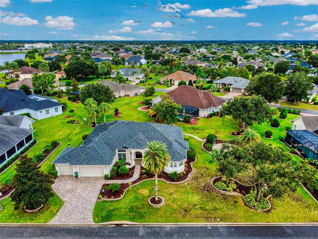 A bright entryway features double doors, a transom window, tile flooring, and two console tables — 649 TERNBERRY FOREST DRIVE, THE VILLAGES, FL
