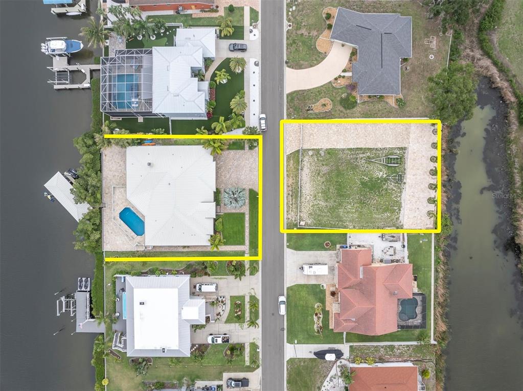 An aerial view shows two adjacent residential lots, one with a house and one vacant — 811 BIRDIE WAY, APOLLO BEACH, FL