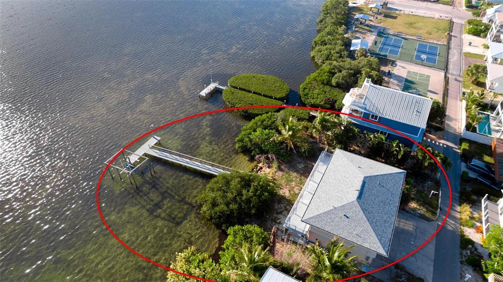 An aerial view of a waterfront house with a private dock and surrounding mangrove trees — 2512 AVENUE A, BRADENTON BEACH, FL