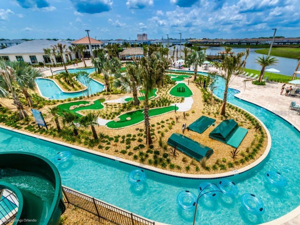 An aerial view of a resort pool area featuring a lazy river and miniature golf course — 4966 WINDERMERE AVENUE, KISSIMMEE, FL