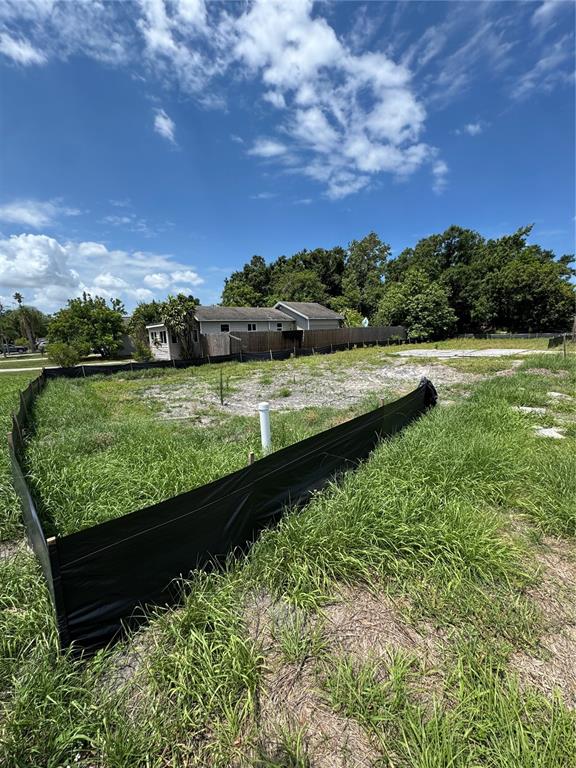 A vacant residential lot features a silt fence and a white utility pipe — 4240 40TH STREET N, ST PETERSBURG, FL