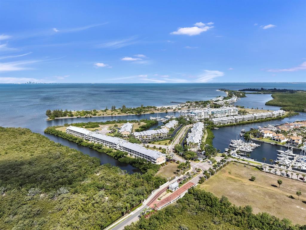 Aerial view of a waterfront residential complex with boat slips and surrounding mangroves — 3202 MANGROVE POINT DRIVE, RUSKIN, FL