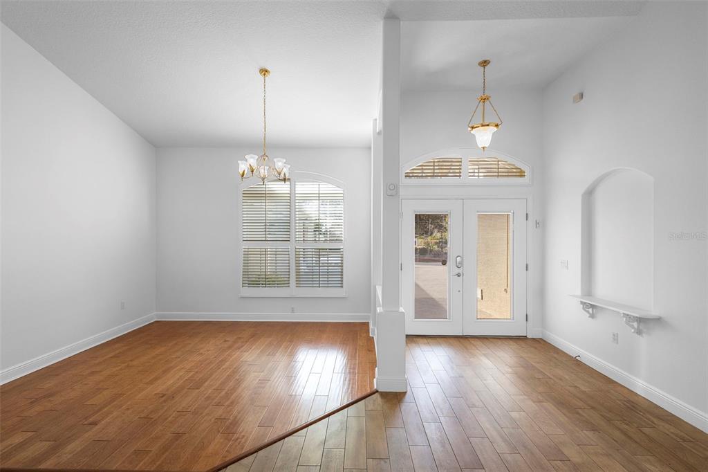 A screened-in patio features a swimming pool with a hot tub and a pool lift — 73 SANCTUARY AVENUE, DEBARY, FL
