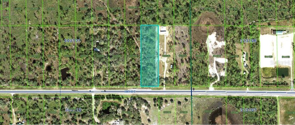 An aerial map view shows a rectangular parcel of land highlighted in blue along a highway — 20901 STATE ROAD 60 E, LAKE WALES, FL
