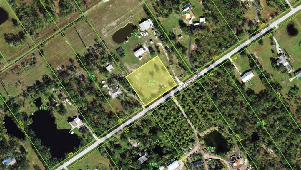 An aerial map view shows a highlighted vacant lot bordered by a road and trees — 7875 CLEVELAND DRIVE, PUNTA GORDA, FL