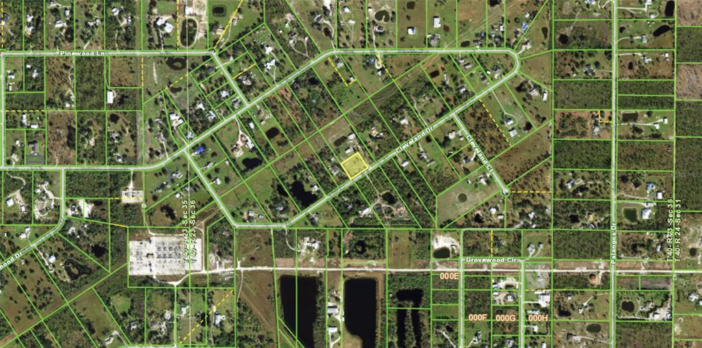This is an aerial map showing a highlighted vacant lot among residential properties and roads — 7875 CLEVELAND DRIVE, PUNTA GORDA, FL
