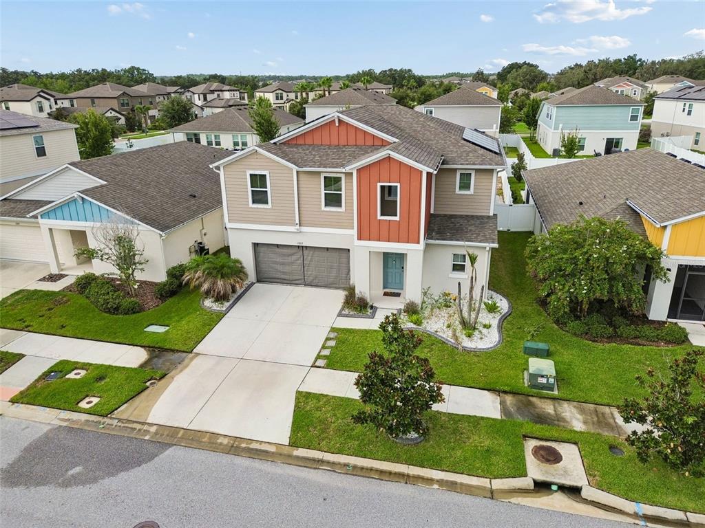 An aerial view of a two-story suburban house with a tan and orange exterior — 13113 FRUITVILLE WAY, RIVERVIEW, FL