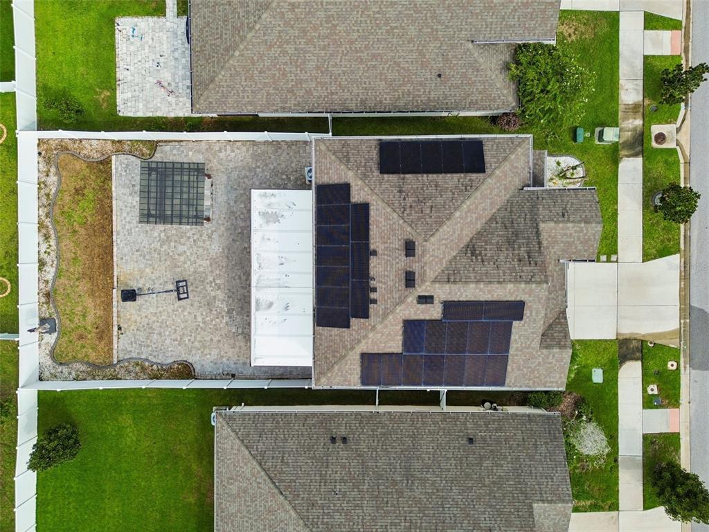 An aerial view shows a house with solar panels on the roof and a paved patio — 13113 FRUITVILLE WAY, RIVERVIEW, FL