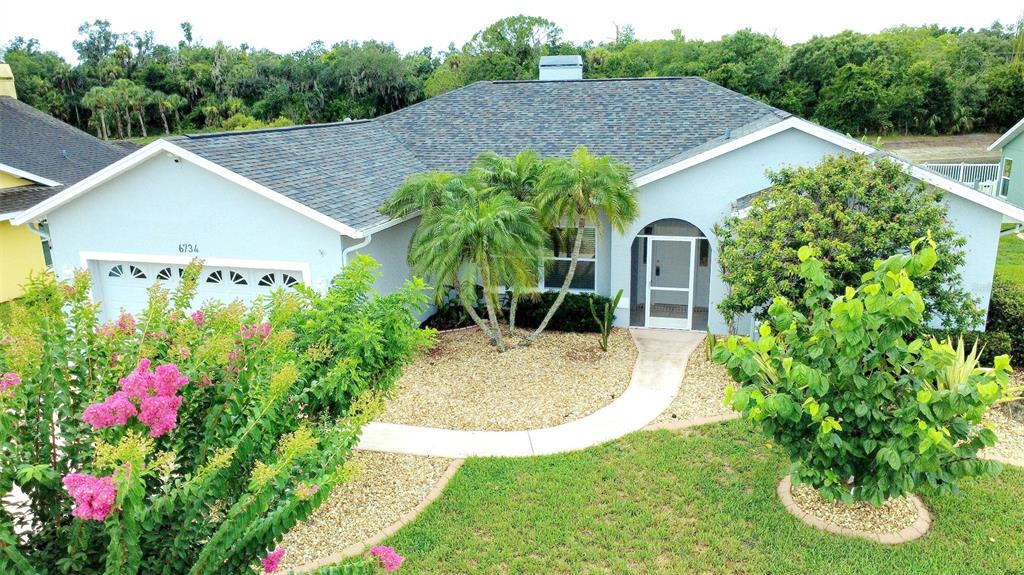 An exterior view of a single-story house with a gray roof and light blue siding — 6734 60TH STREET CIRCLE E, PALMETTO, FL