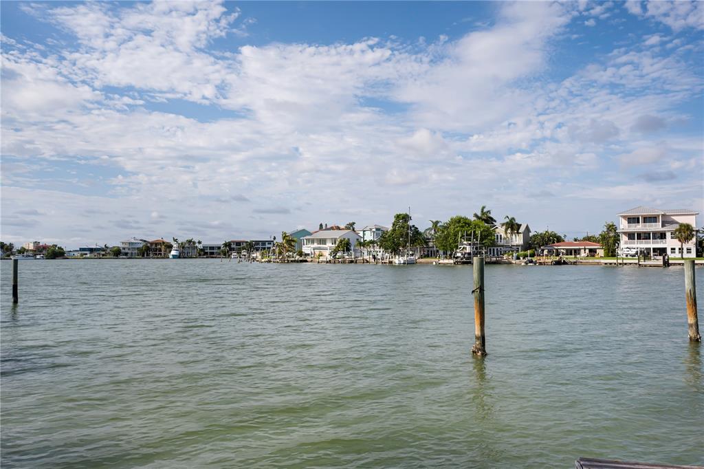 A view of a waterfront neighborhood with houses and docks along the shoreline — 14035 E PARSLEY DRIVE, MADEIRA BEACH, FL