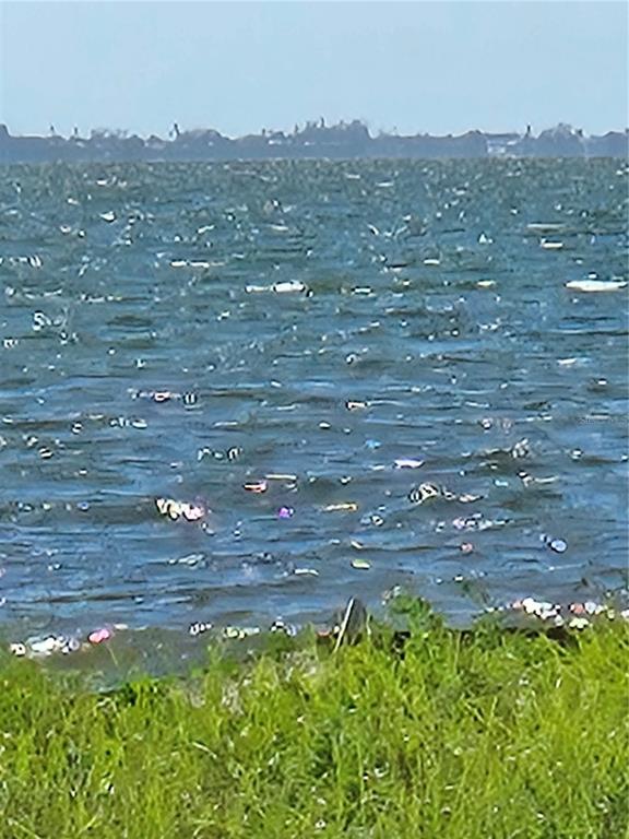 A view of a body of water with a grassy shoreline in the foreground — 333 N. SHORE DRIVE, SARASOTA, FL