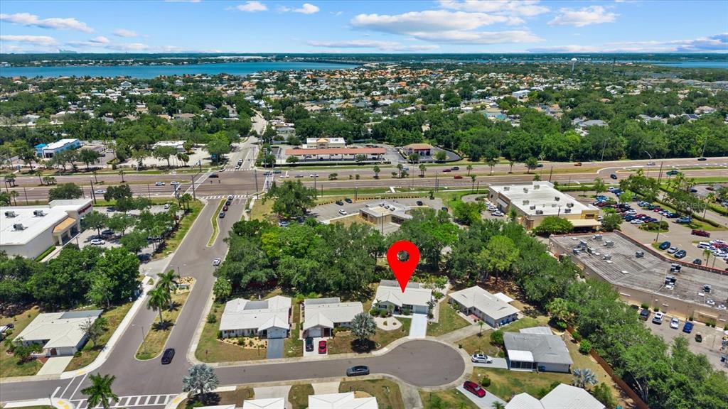 An aerial view shows a residential house marked with a red pin in a neighborhood — 4305 CHINABERRY CIRCLE, BRADENTON, FL