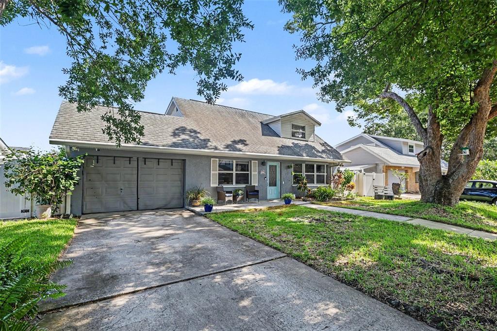 A gray two-story house with a concrete driveway, a two-car garage, and a front porch — 12321 82ND AVE, SEMINOLE, FL