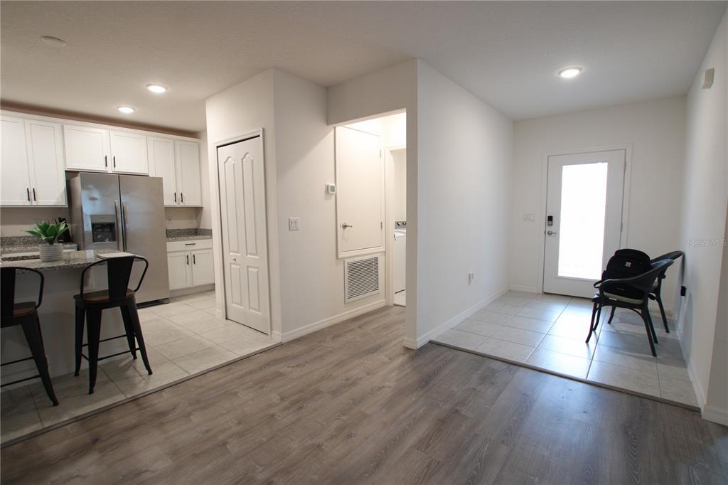 A kitchen with stainless steel appliances and a tiled entryway with a glass-paneled door — 516 INGLESIDE LANE, HAINES CITY, FL