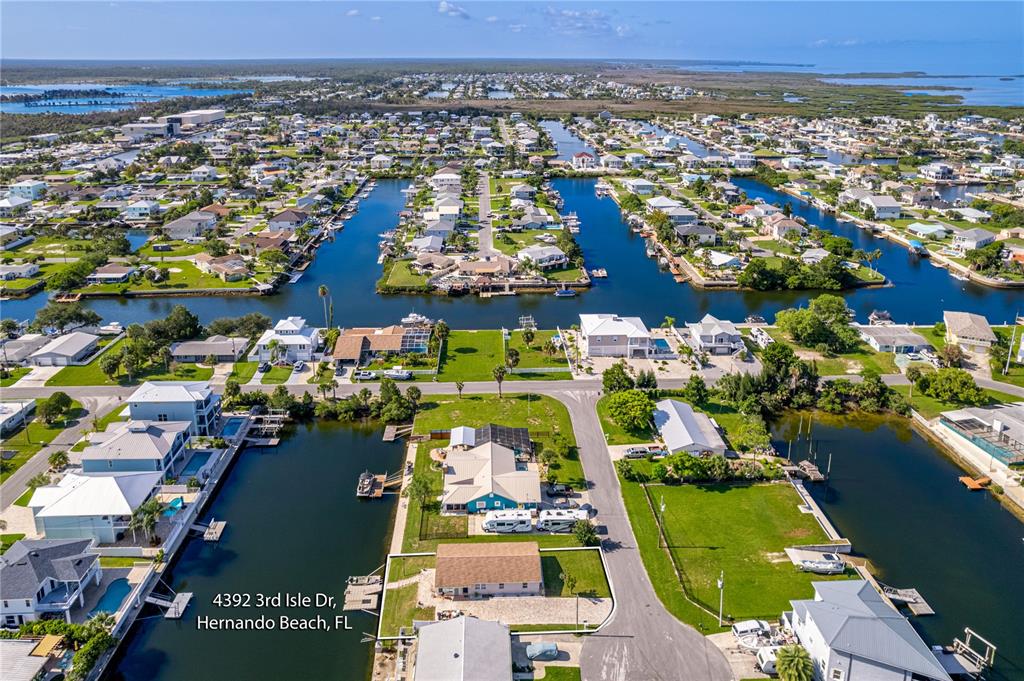 An aerial view shows waterfront homes with private docks along a canal in Florida — 4392 3RD ISLE DRIVE, HERNANDO BEACH, FL