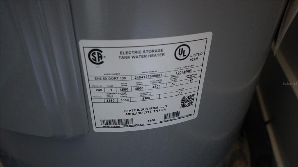 This is a close-up photo of a State Industries electric water heater manufacturer's specification label — 15405 GULF BOULEVARD UNIT B2, MADEIRA BEACH, FL