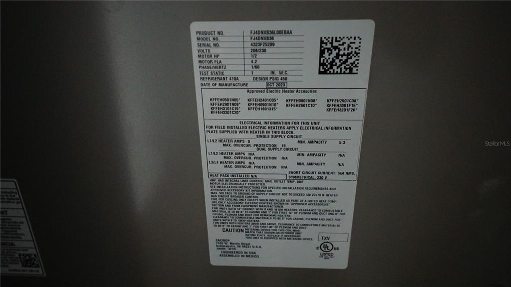 A close-up view of an HVAC unit data plate showing technical specifications and manufacturing details — 15405 GULF BOULEVARD UNIT B2, MADEIRA BEACH, FL