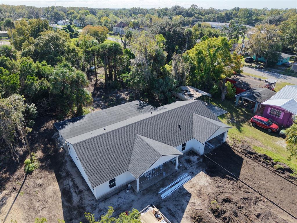 An aerial view of a newly constructed white house with a dark shingled roof — 101 YAWN AVENUE, INTERLACHEN, FL