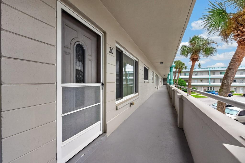 An exterior walkway leads to a unit door marked with the number 30 — 2370 JAMAICAN STREET UNIT 30, CLEARWATER, FL