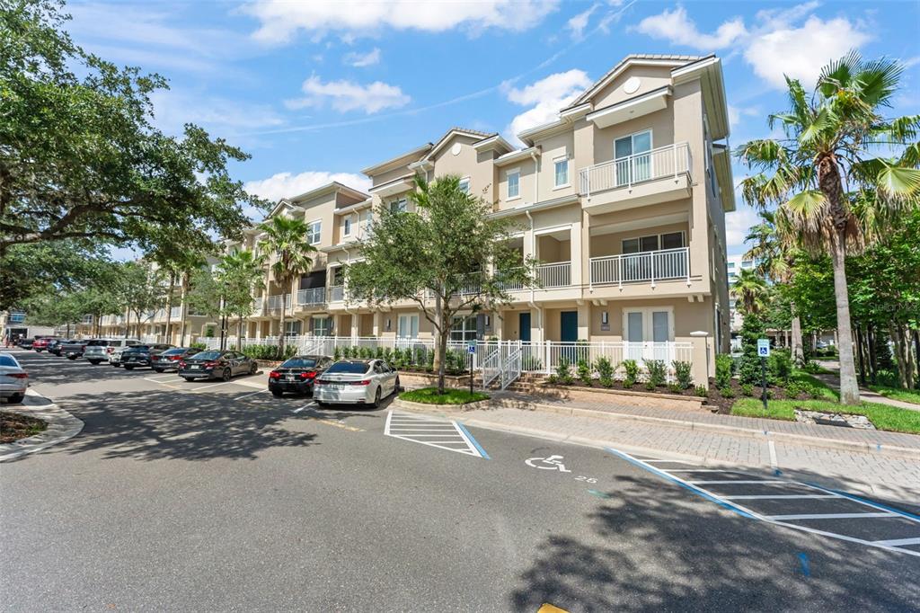 A patio area features a blue front door, outdoor seating, and a small potted plant — 1457 LAKE GEORGE DRIVE UNIT 1457, LAKE MARY, FL